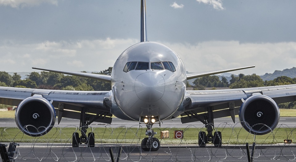 plane on a runway, kicking up fumes